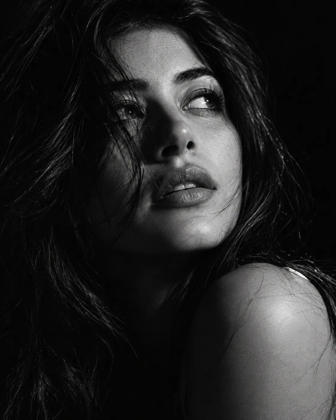 Female dramatic black and white close-up portrait gazing upward